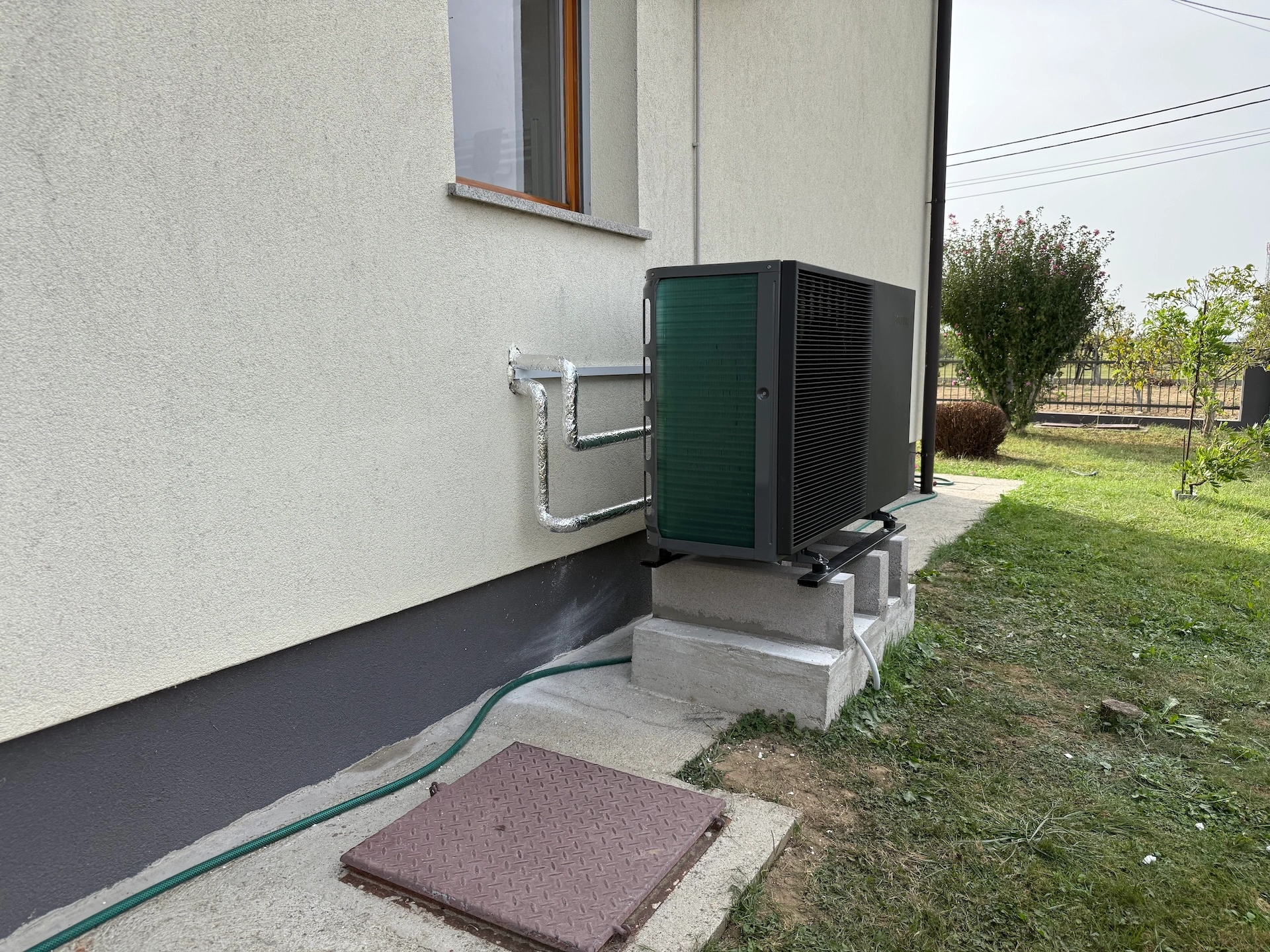 Vanjska jedinica dizalice topline na fasadi kuće